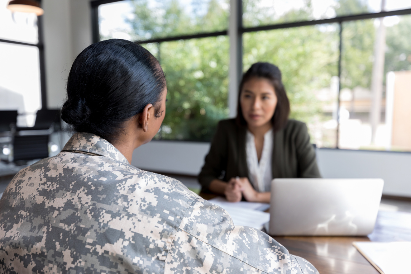 Rear view of female veteran talking with counselor
